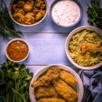 Five visually distinct ranch chicken recipes styled together on a rustic table, showcasing creamy, crispy, spicy, and cheesy flavors.